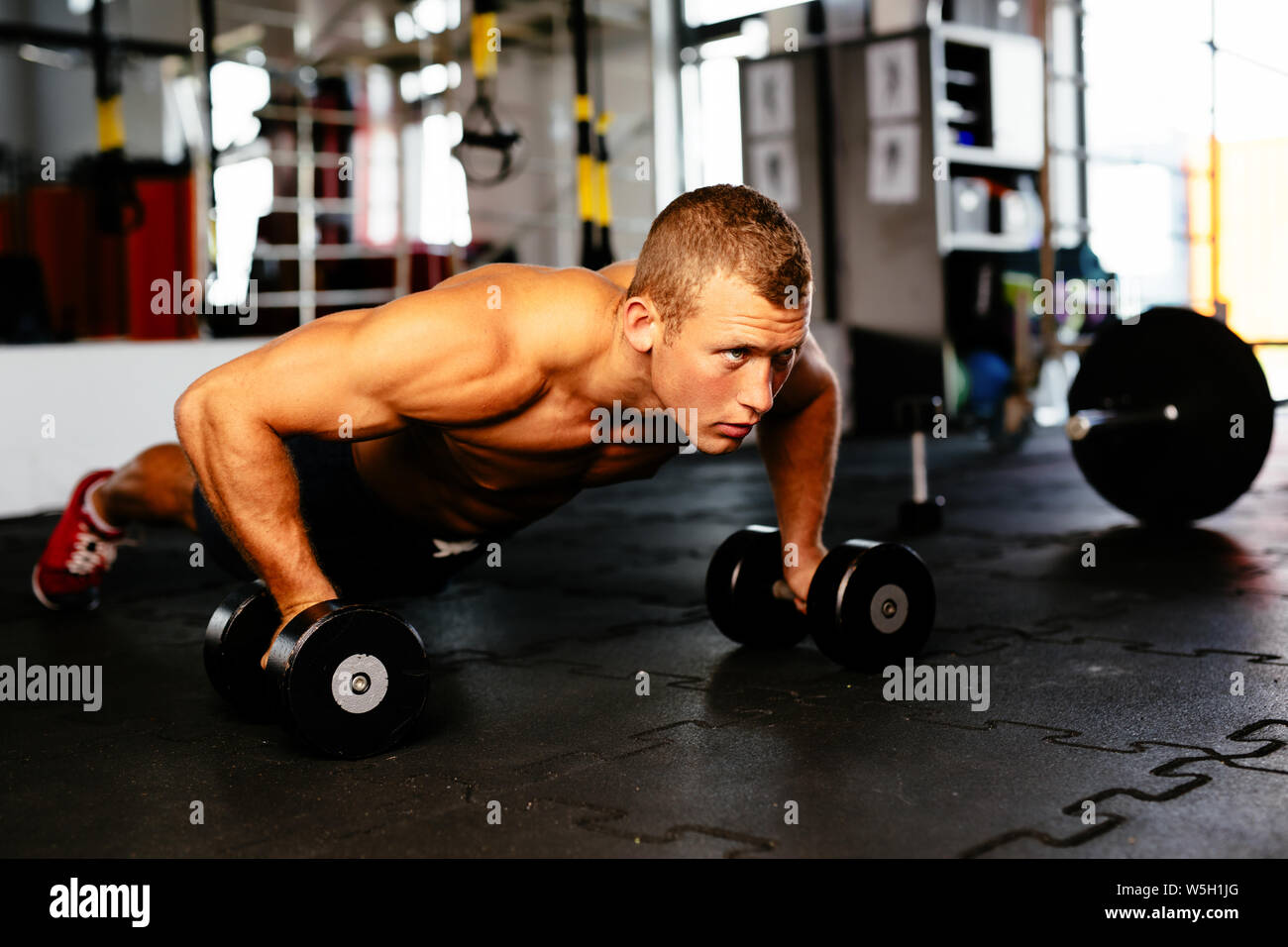 Young muscular athlete doing pushups Stock Photo