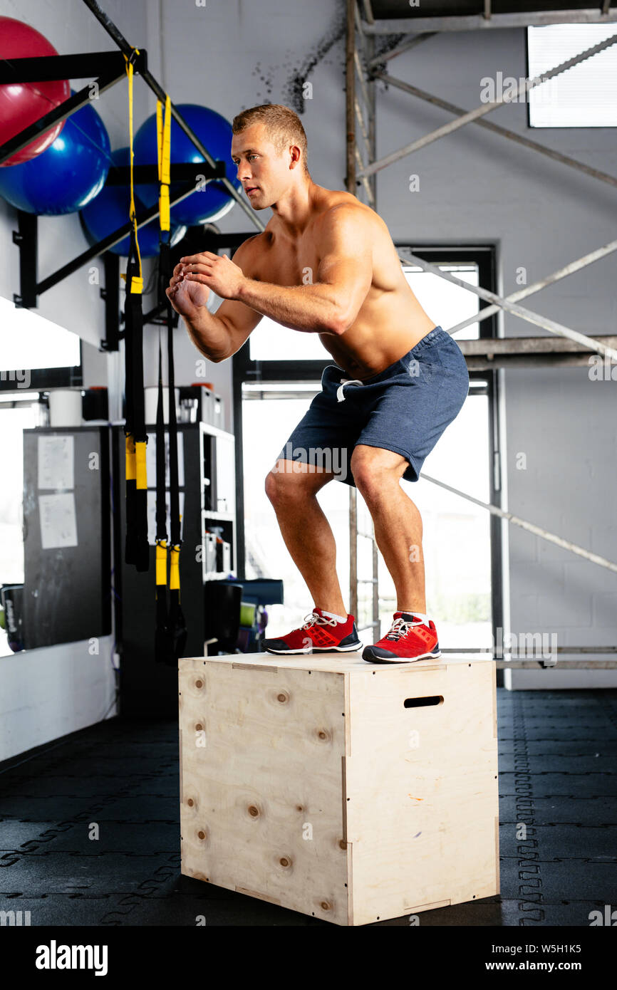 Young muscular man perfecting the box jump. Crossfit training Stock Photo -  Alamy