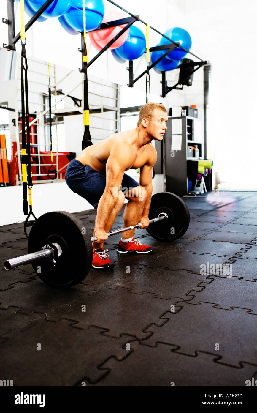 Young muscular athlete practicing deadlift Stock Photo