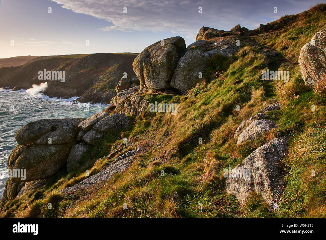 Warm light on Rospletha cliff, Porthchapel, Porthcurno, Cornwall, England, United Kingdom, Europe Stock Photo