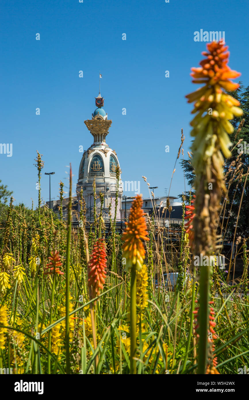 Tour Lu in Nantes on a Sunny Summer Day with Green Vegetation and Orange Common Torch Lilly Flowers Stock Photo