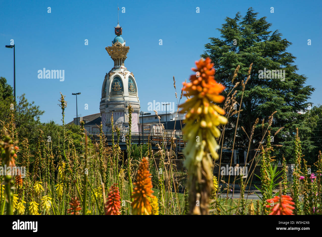 Tour Lu in Nantes on a Sunny Summer Day with Green Vegetation and Orange Common Torch Lilly Flowers Stock Photo