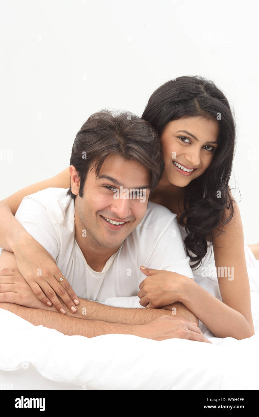 Couple romancing on the bed Stock Photo - Alamy