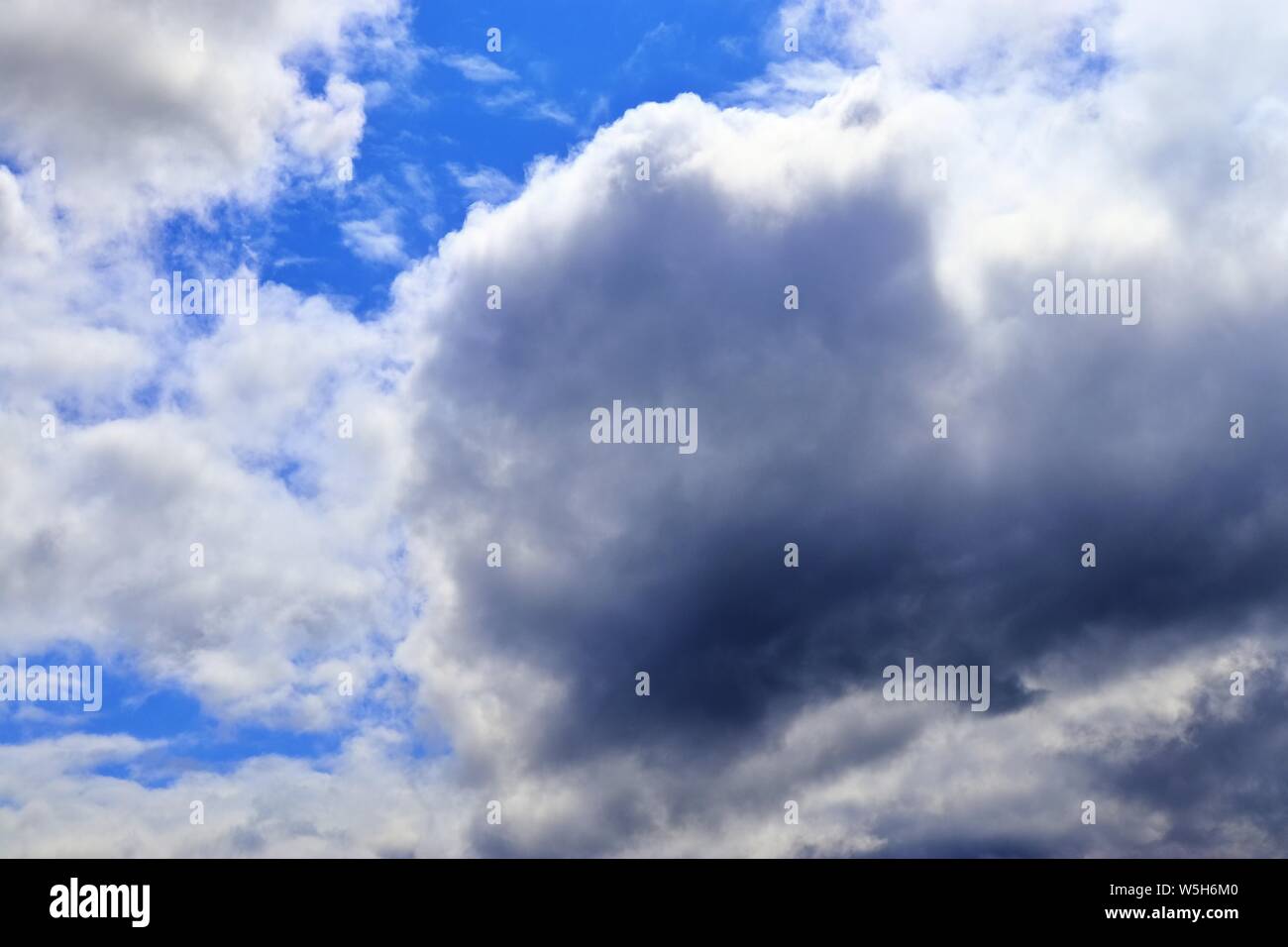 Beautiful white fluffy clouds on a deep blue summer sky Stock Photo - Alamy