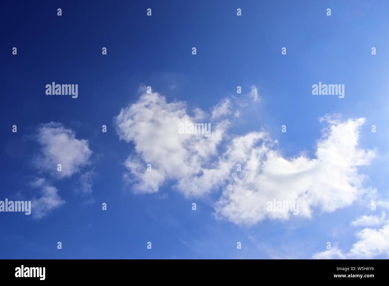 Beautiful white fluffy clouds on a deep blue summer sky Stock Photo - Alamy