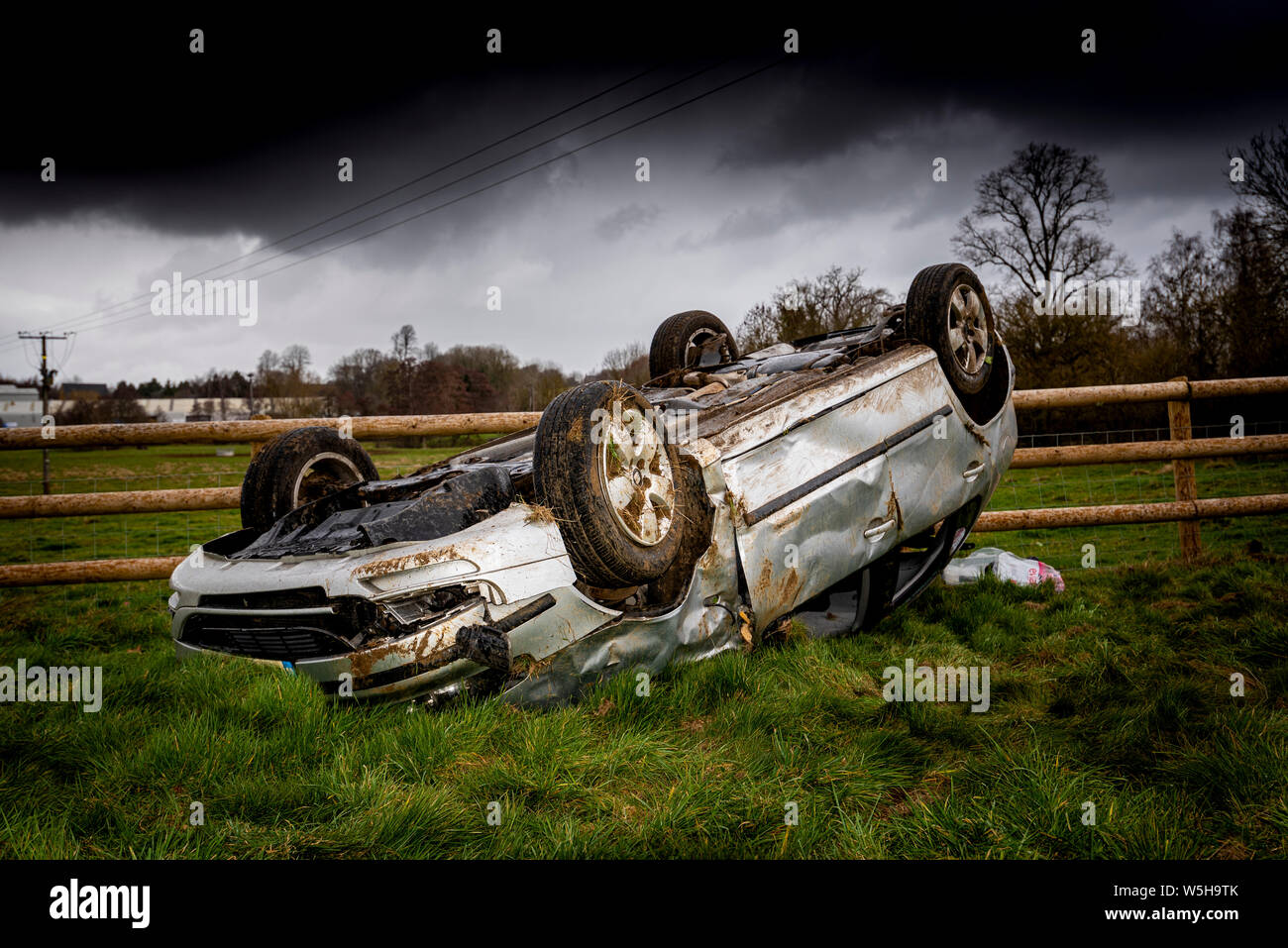 Car crash. Young drivers overturned vehicle. Non fatal accident caused by speeding and rain. Inexperienced driver / Rural crime / Stolen car / rtc. UK Stock Photo