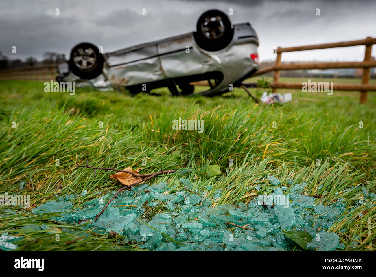 Car crash. Young drivers overturned vehicle. Non fatal accident caused by speeding and rain. Inexperienced driver / Rural crime / Stolen car / rtc. UK Stock Photo