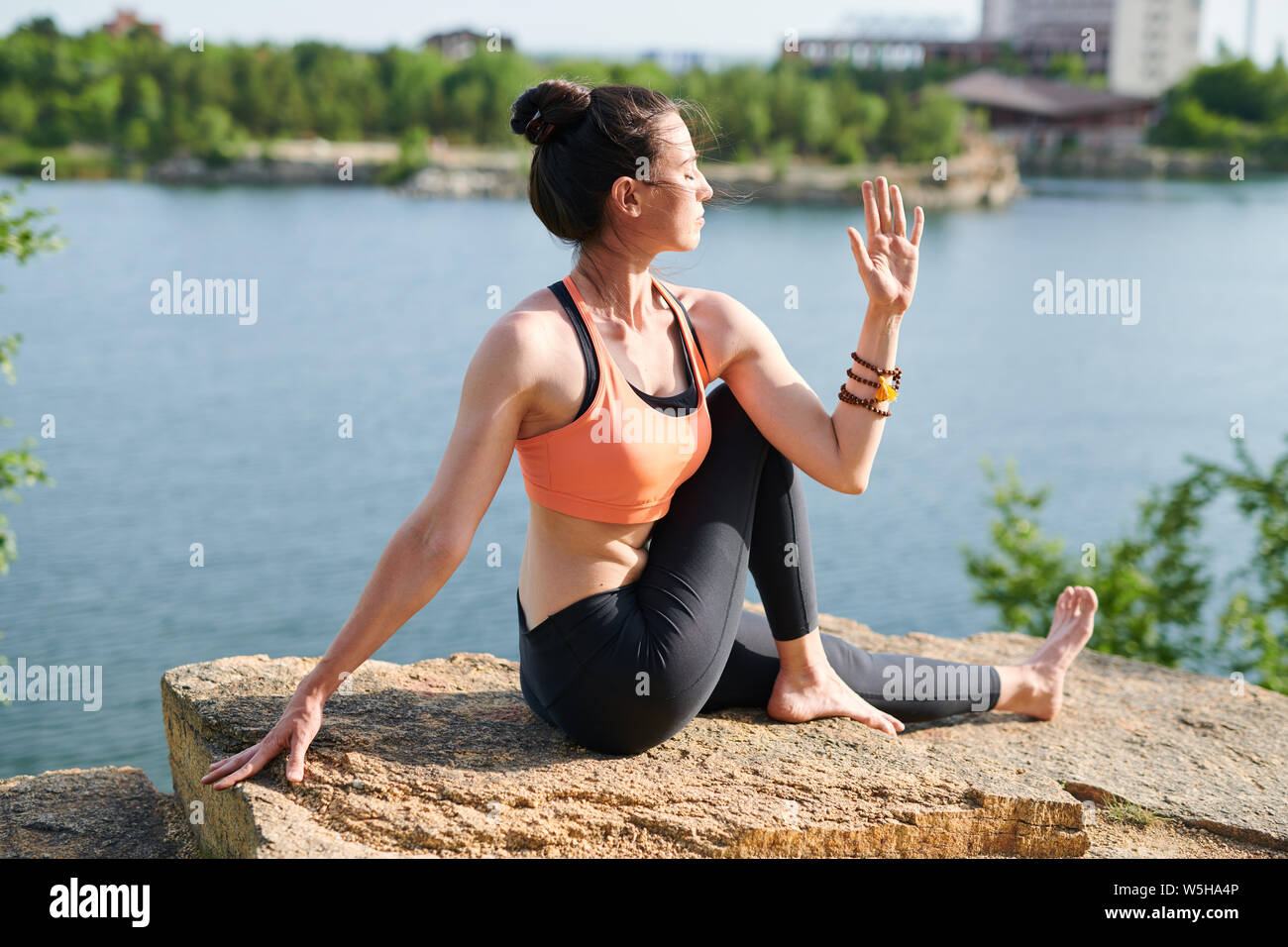 Energizing spine with half lord of fishes pose Stock Photo