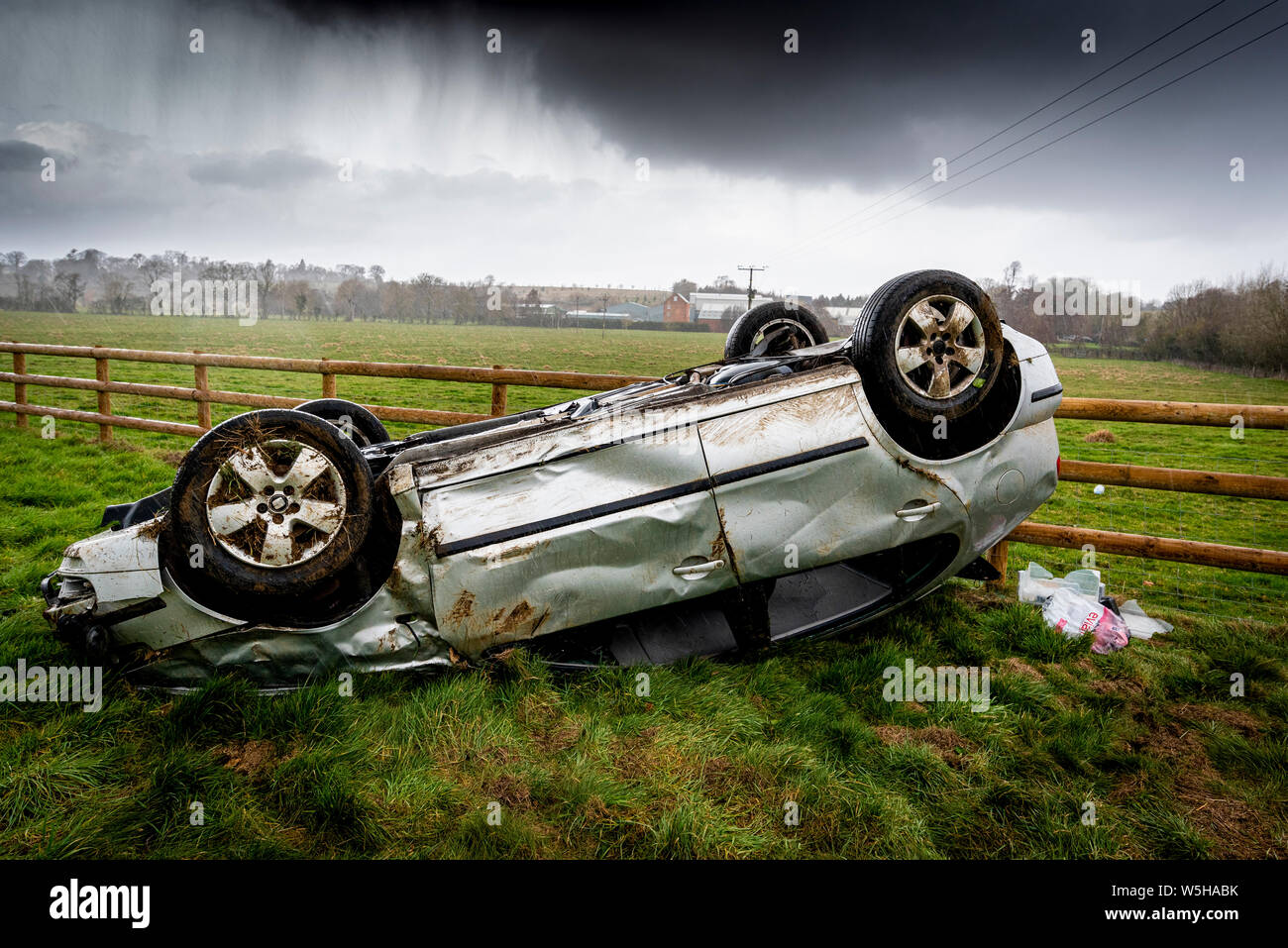 Car crash. Young drivers overturned vehicle. Non fatal accident caused by speeding and rain. Inexperienced driver / Rural crime / Stolen car / rtc. UK Stock Photo