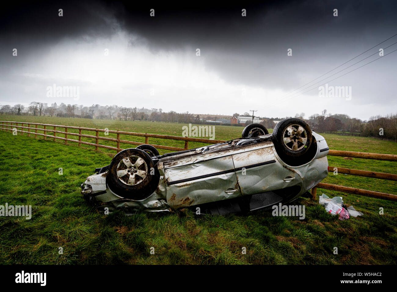 Car crash. Young drivers overturned vehicle. Non fatal accident caused by speeding and rain. Inexperienced driver / Rural crime / Stolen car / rtc. UK Stock Photo