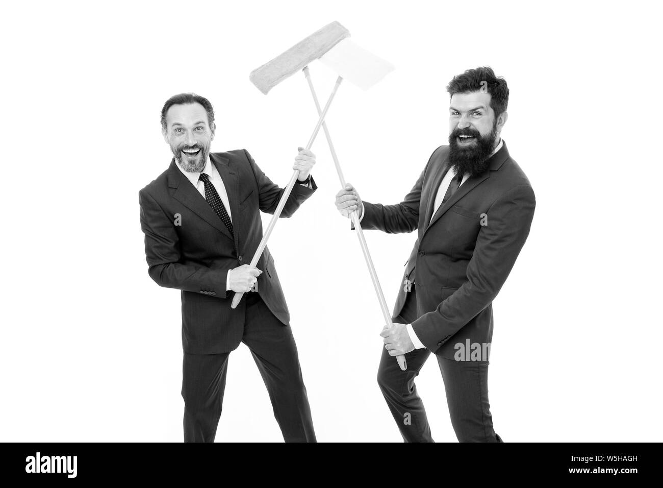 Partnership and teamwork. clean slate. Partnership of businessmen clear wall to white. cleaning company. clean business. mature bearded men in formal suit hold householding mop. successful teamwork. Stock Photo