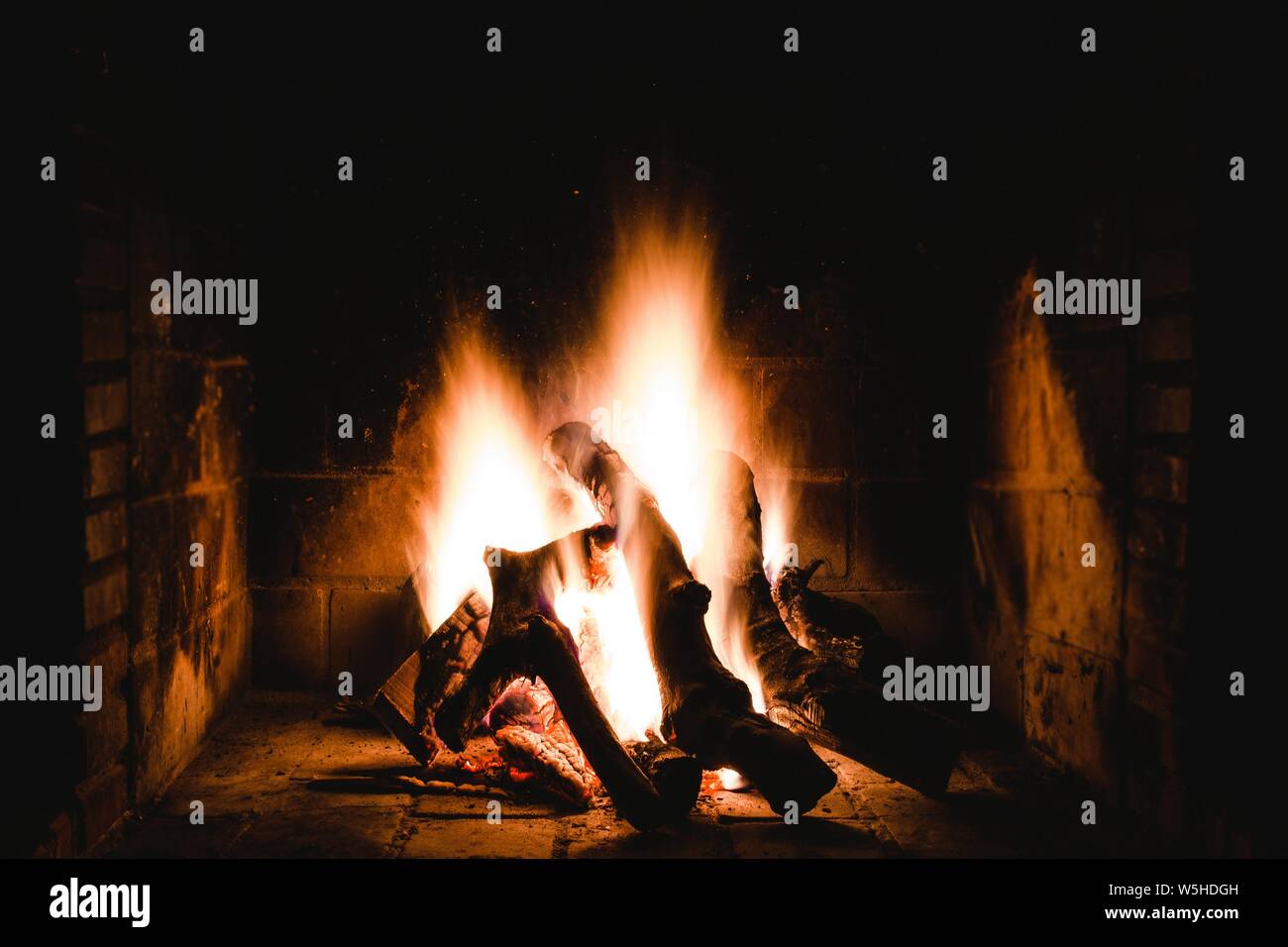 Unique shot of an indoor flamy fireplace Stock Photo