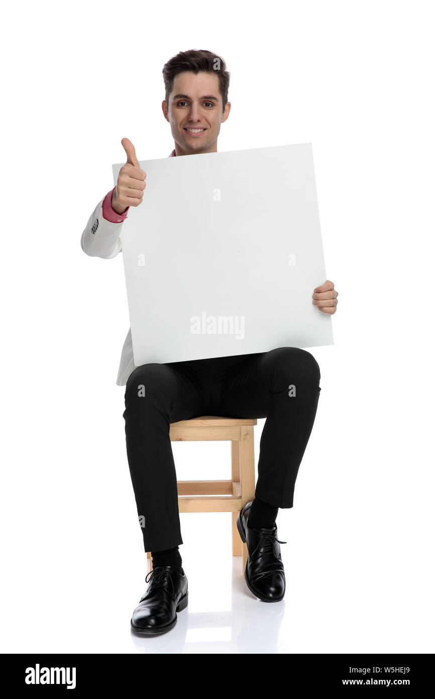 seated businessman holding blank board makes the ok sign on white ...