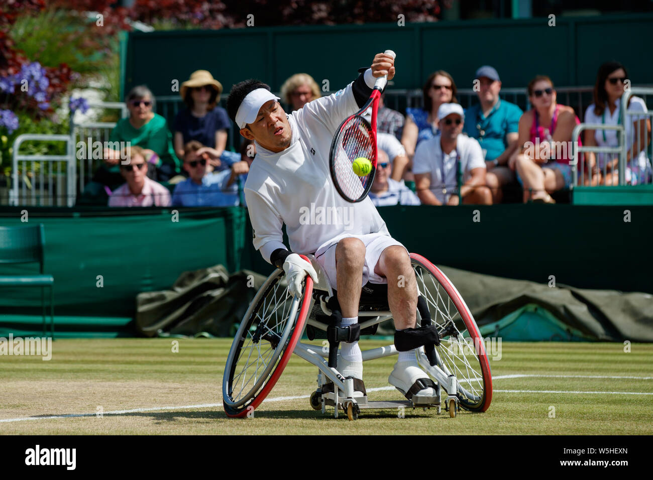 Koji Sugeno of Japan playing Quad Singles at The Championships , Wimbledon 2019 with Number 1 Court behind. Held at The All England Lawn Tennis Club, Stock Photo