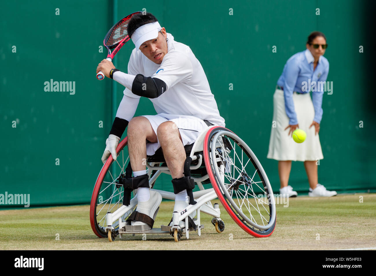 Koji Sugeno of Japan playing Quad Singles at The Championships , Wimbledon 2019 with Number 1 Court behind. Held at The All England Lawn Tennis Club, Stock Photo
