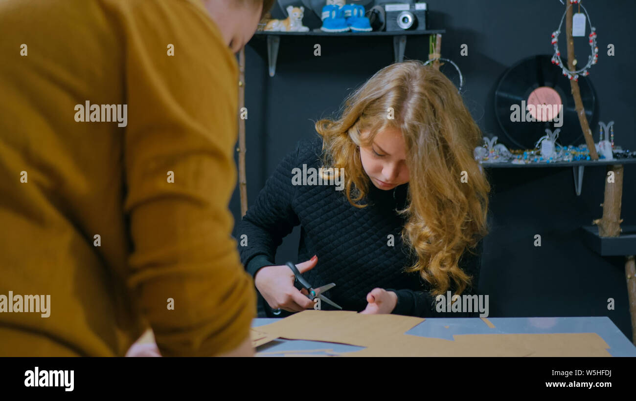 Two professional women decorators, designers working with kraft paper