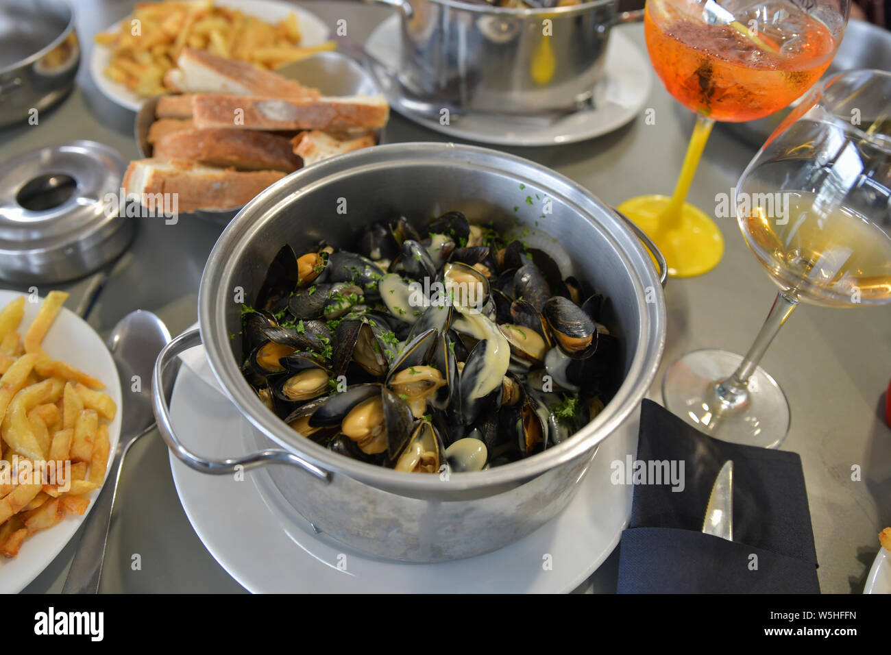 Mussels with french fries and beer in a restaurant Stock Photo Alamy