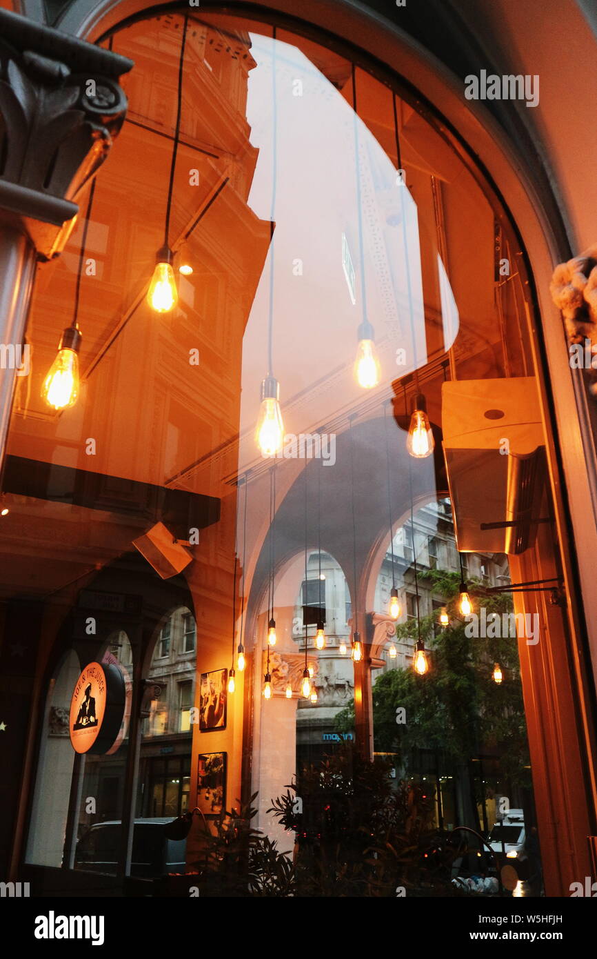 The interior of a london coffee shop shot through a window. Stock Photo