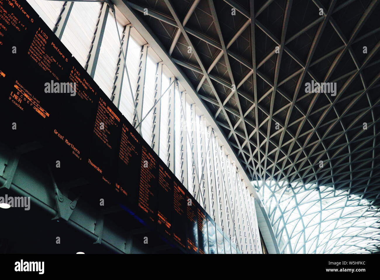 A train departure timetable under the roof of Charing Cross Station in London, UK. Stock Photo