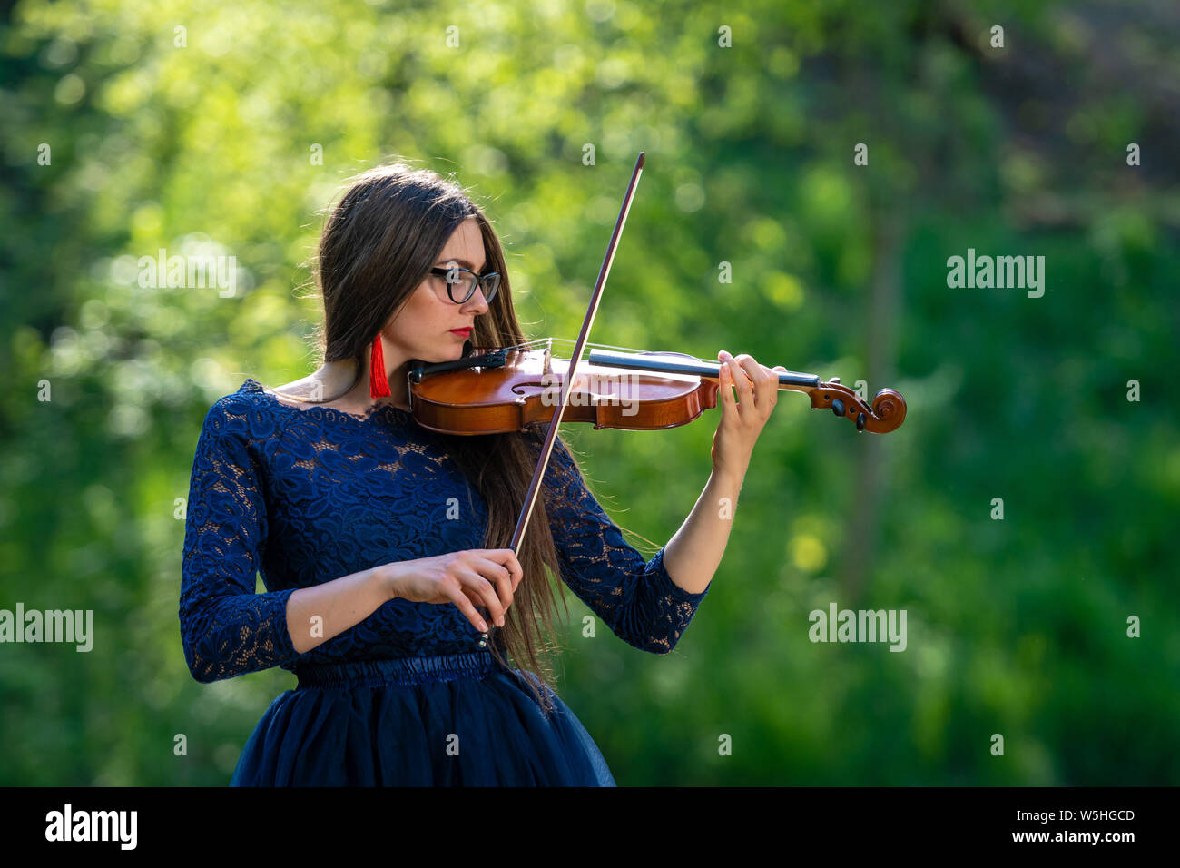 Young woman playing the violin at park. Shallow depth of field Stock ...