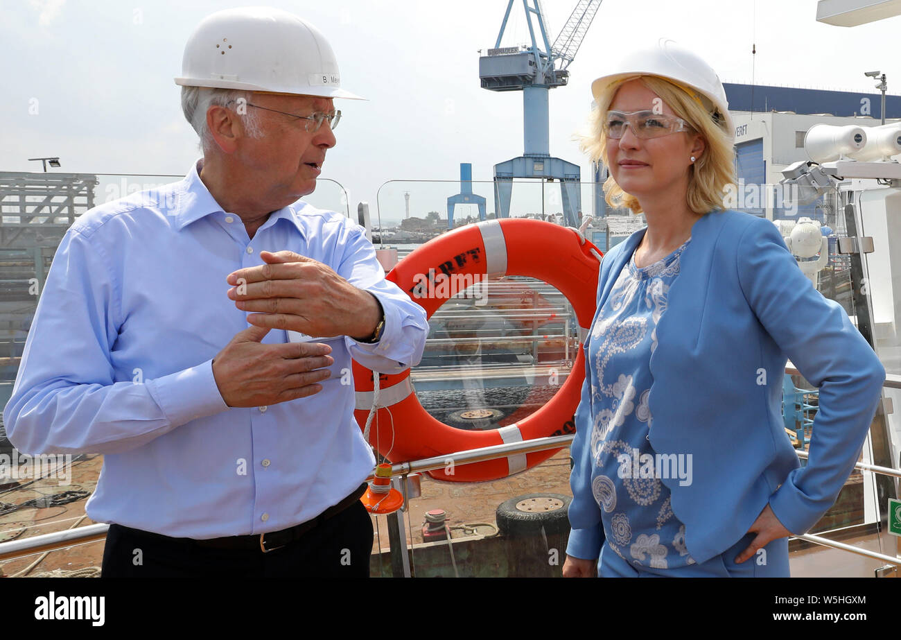 29 July 2019, Mecklenburg-Western Pomerania, Rostock: Bernard Meyer (l-r), member of the management board of Meyer Werft Papenburg, informs in the Neptun Werft Manuela Schwesig (SPD), Prime Minister of Mecklenburg-Vorpommern, about the construction of river cruise ships. At the beginning of the second week of the tour, the head of government dedicates herself to cruise tourism. Photo: Bernd Wüstneck/dpa-Zentralbild/dpa Stock Photo