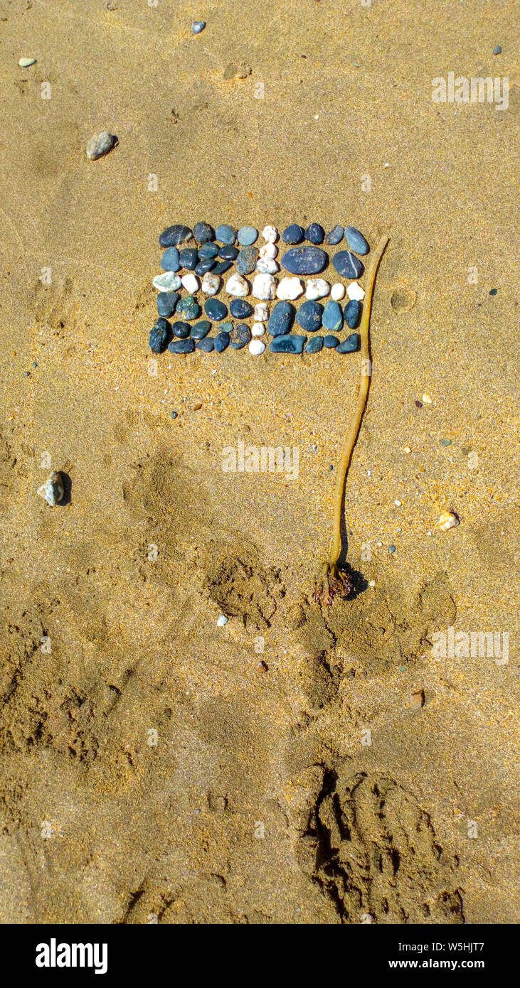 Hand made art of Cornish Flag of stones and seaweed Stock Photo