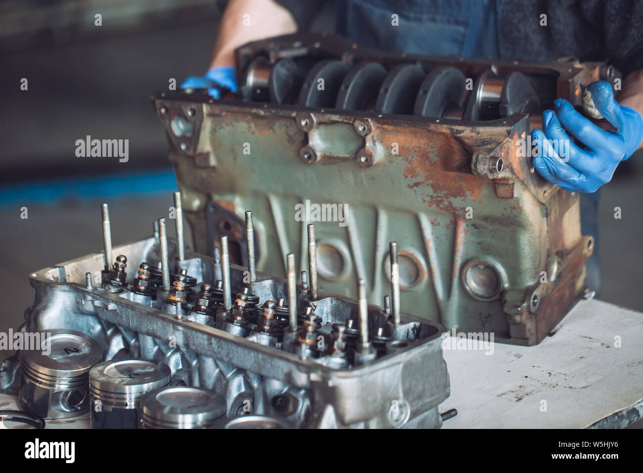 Master collects a rebuilt motor for the car Stock Photo Alamy