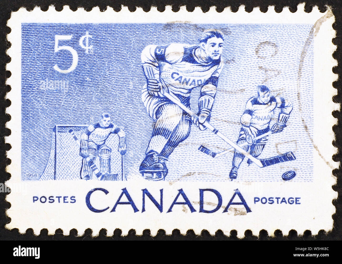 Ice hockey players on vintage canadian postage stamp Stock Photo