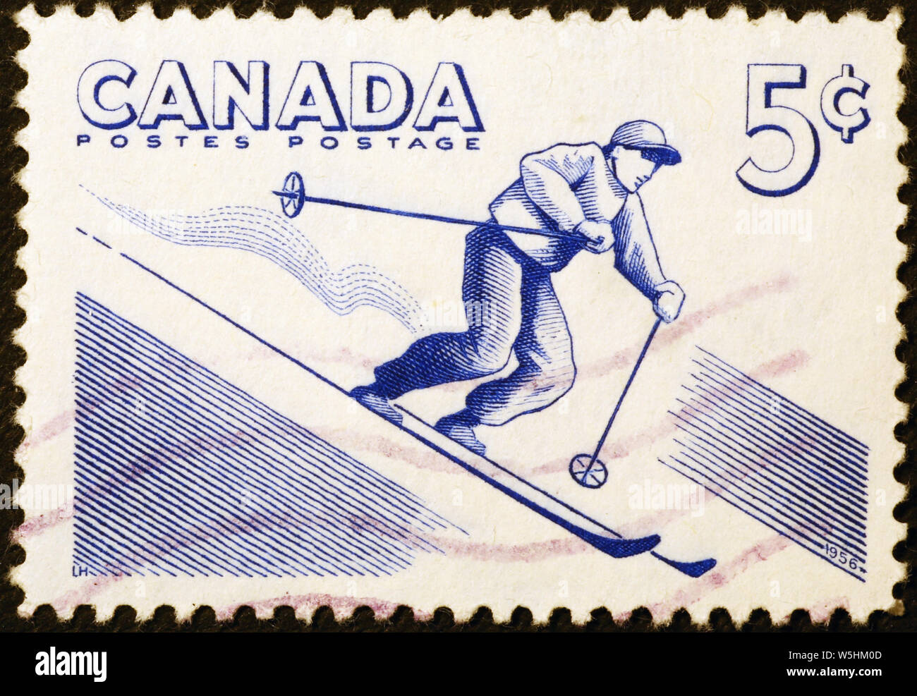 Skier on vintage canadian postage stamp Stock Photo
