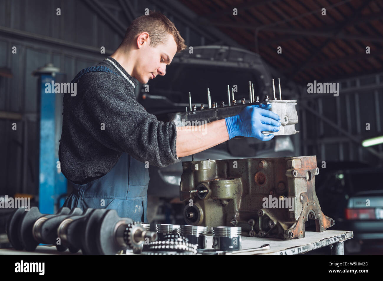 Master collects a rebuilt motor for the car Stock Photo - Alamy