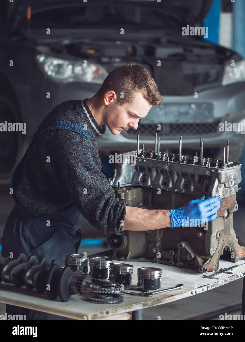 Master collects a rebuilt motor for the car Stock Photo Alamy