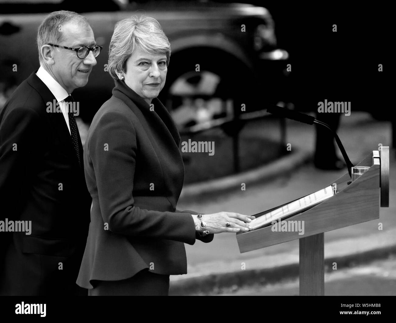 Theresa May with her husband Philip in Downing Street delivering her last speech as Prime Minister before leaving to hand in her resignation to the Qu Stock Photo