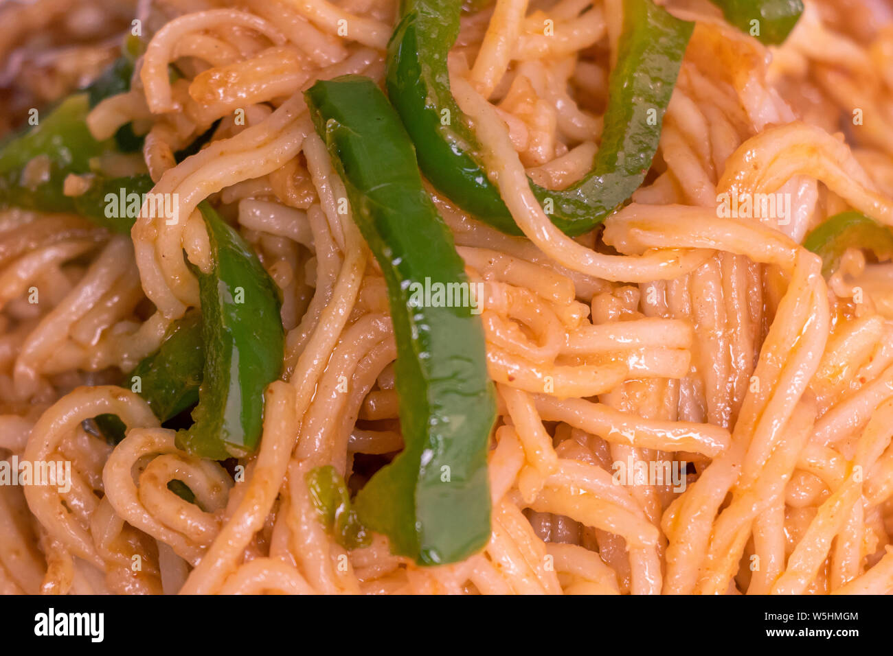 Delicious Noodles closeup, chinese food fried noodles with green pepper