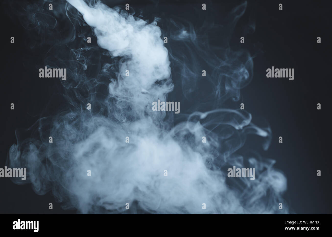Abstract blue smoke isolated on dark background Stock Photo - Alamy