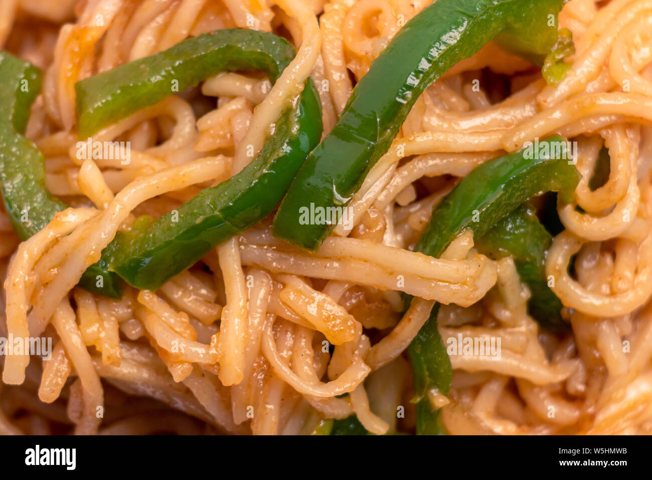 Delicious Noodles closeup, chinese food fried noodles with green pepper