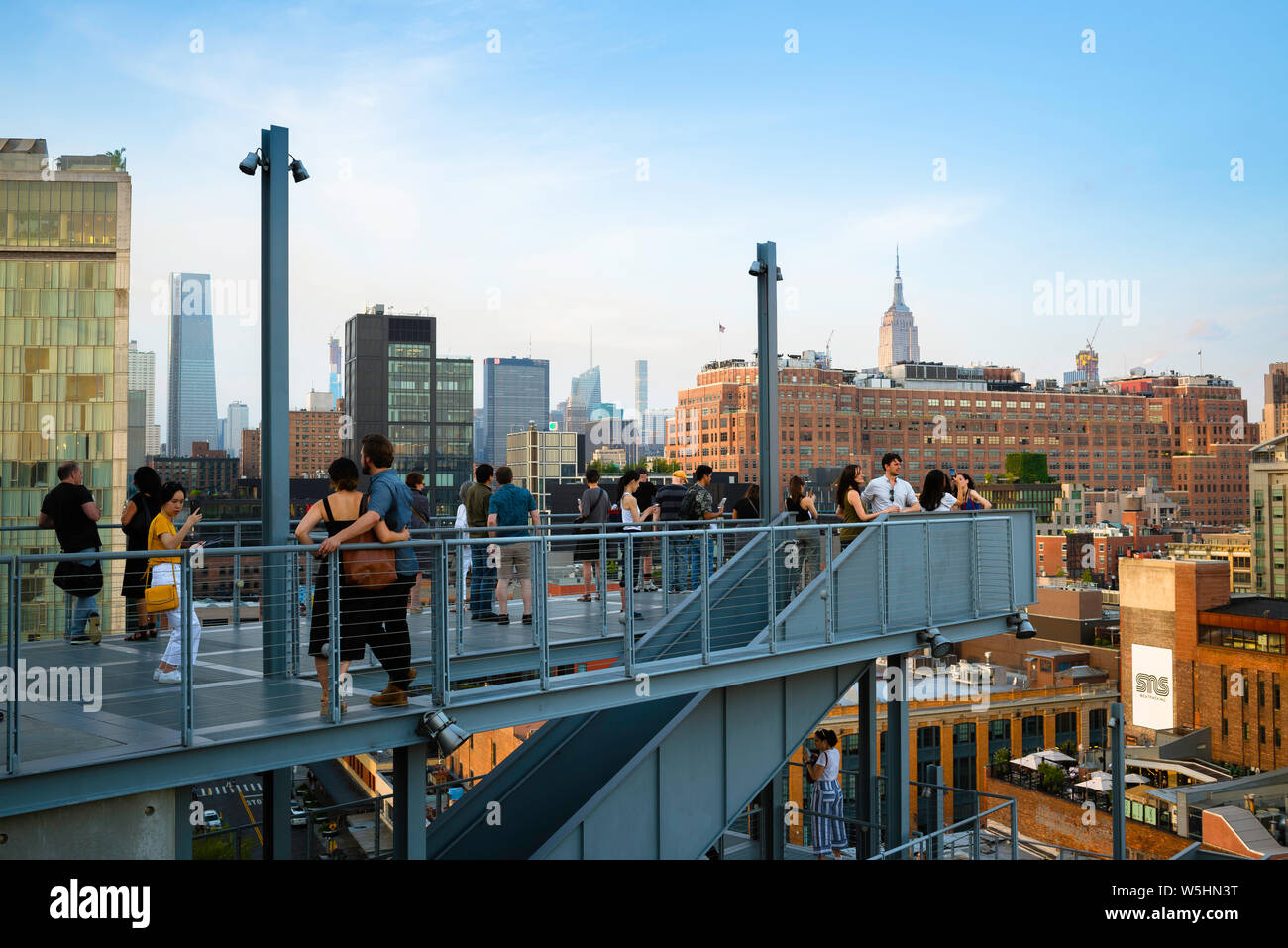 New York people, view on a summer evening of people on the Whitney Museum observation terrace looking towards Midtown Manhattan, New York City, USA. Stock Photo