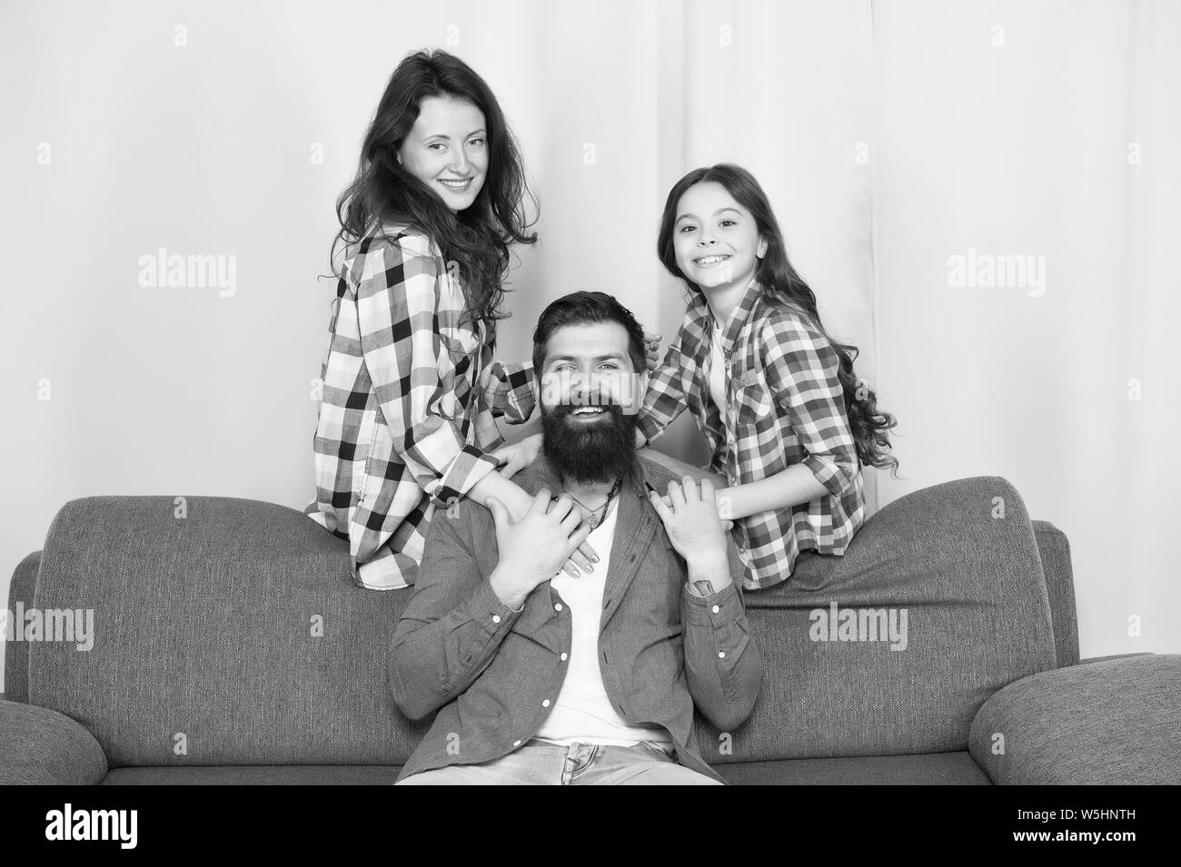 Family relaxing together on couch Black and White Stock Photos & Images