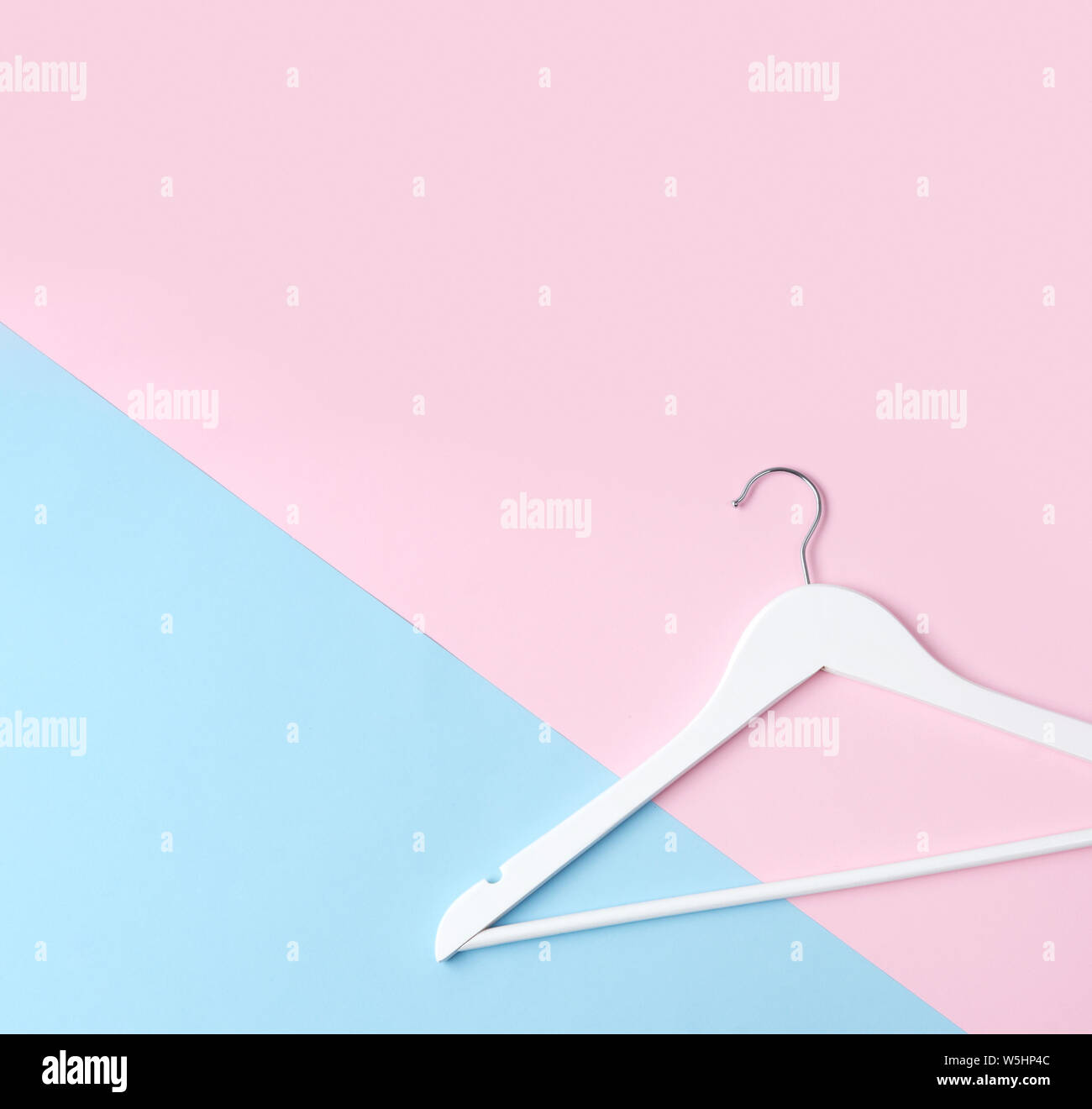 Top view flat lay single white wooden hanger pink and blue pastel  background. Fashion feminine blog sale store promo design shopping concept  Stock Photo - Alamy