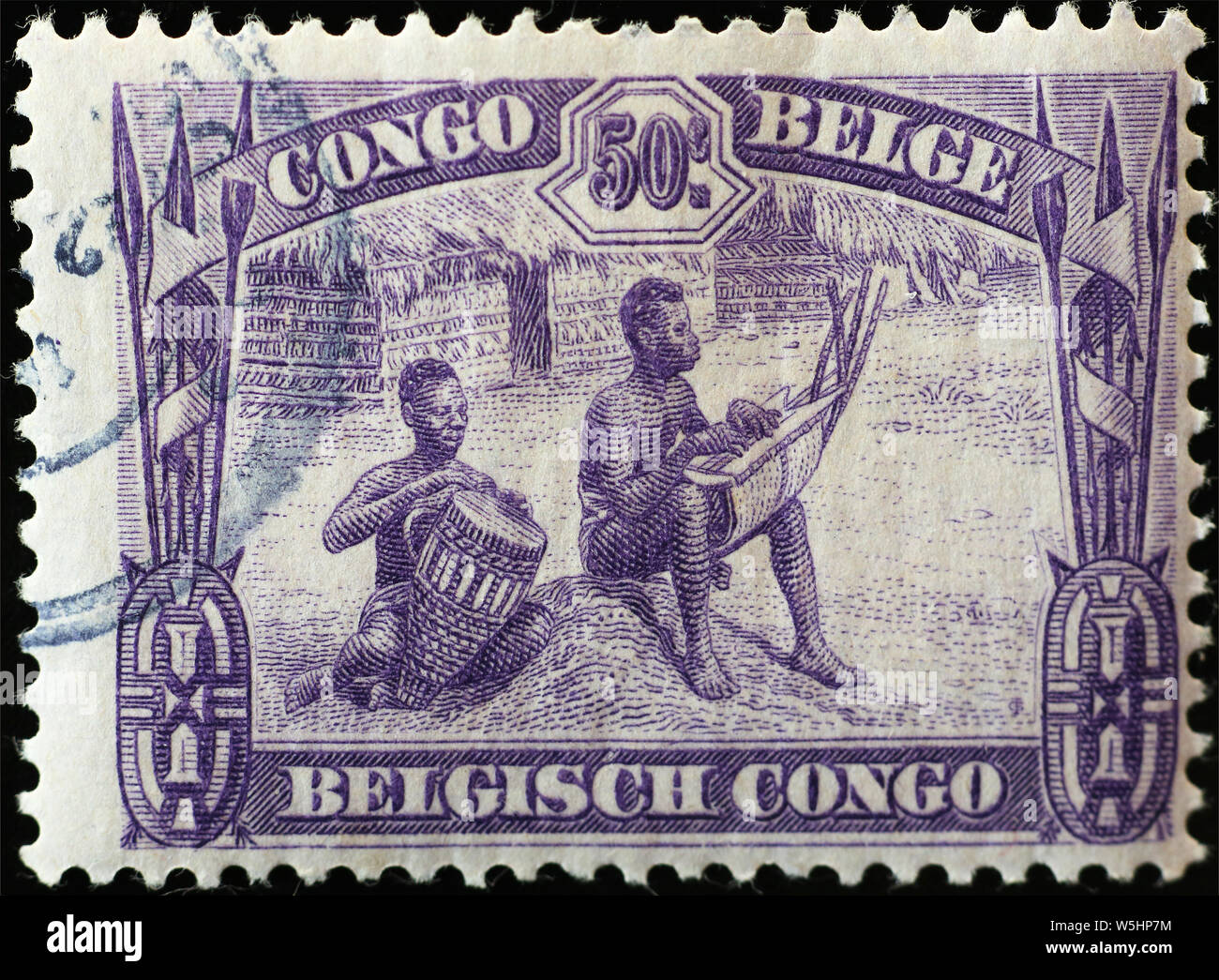 Two men playing instruments on antique african stamp Stock Photo