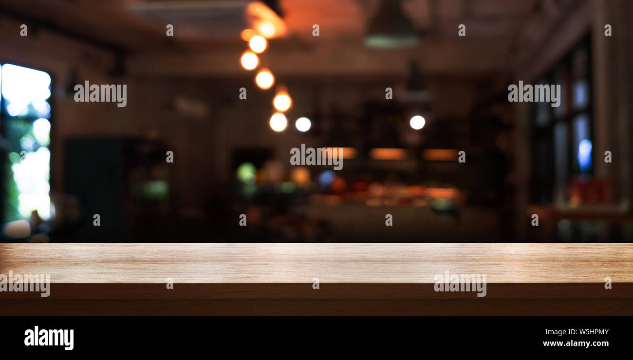 Empty Wooden Table Top With Blur Coffee Shop Or Restaurant