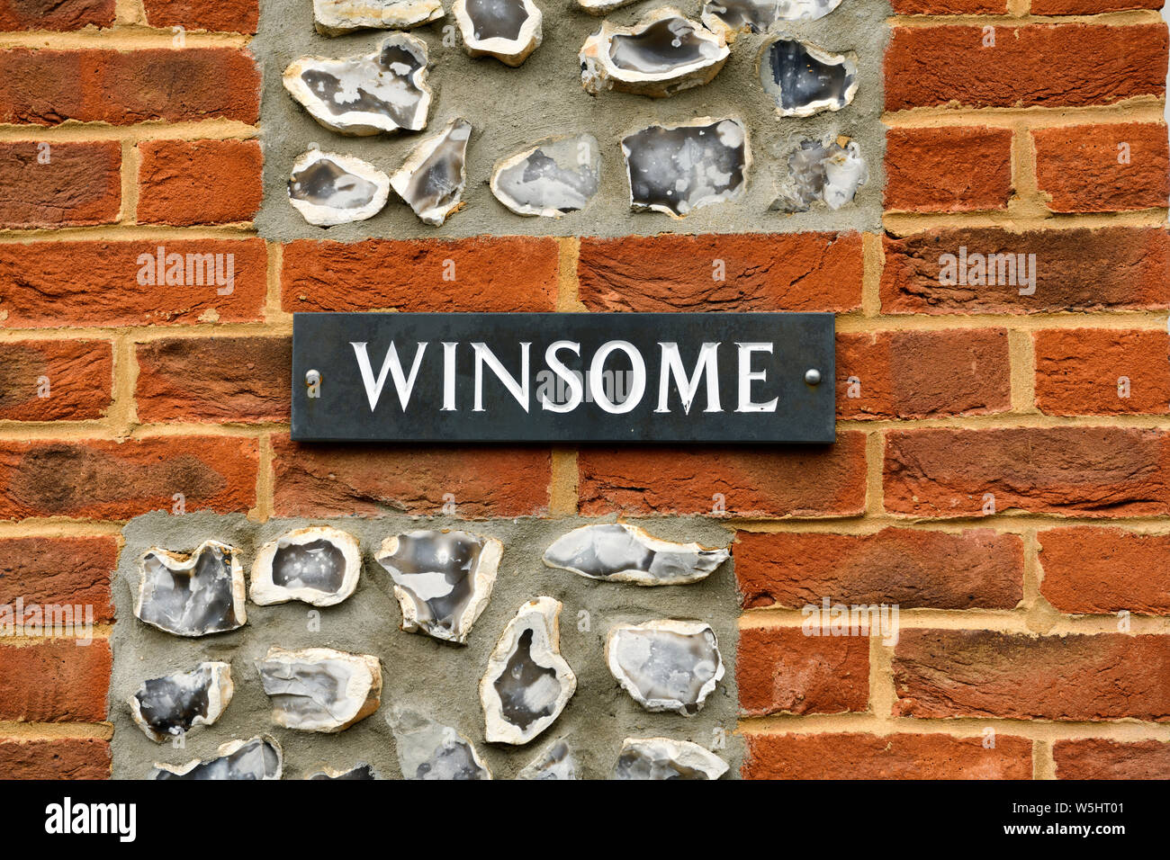 Detail of a red brick house with embedded split flint nodules at