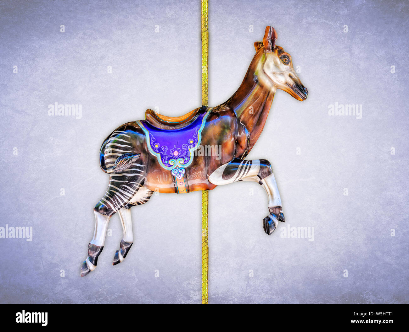 Carnival carousel okapi isolated on blue or gold background Stock Photo
