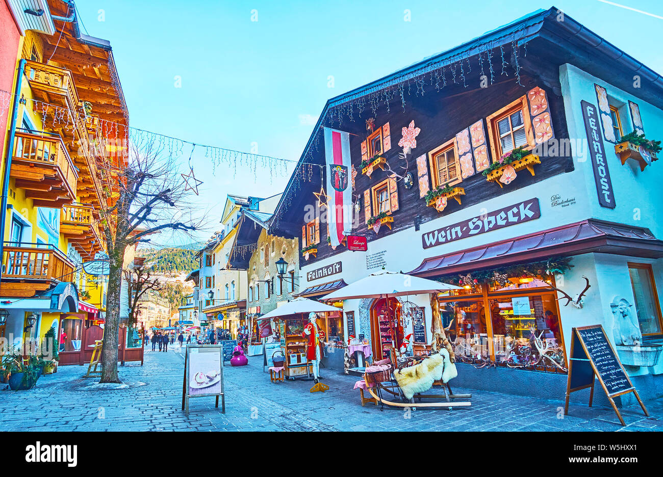 ZELL AM SEE, AUSTRIA - FEBRUARY 28, 2019: The souvenir shops and tourist stores are decorated with garlands, flags, lanterns and examples of their goo Stock Photo
