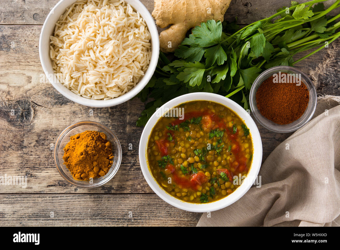 Indian lentil soup dal (dhal) in a bowl on wooden table. Top view Stock