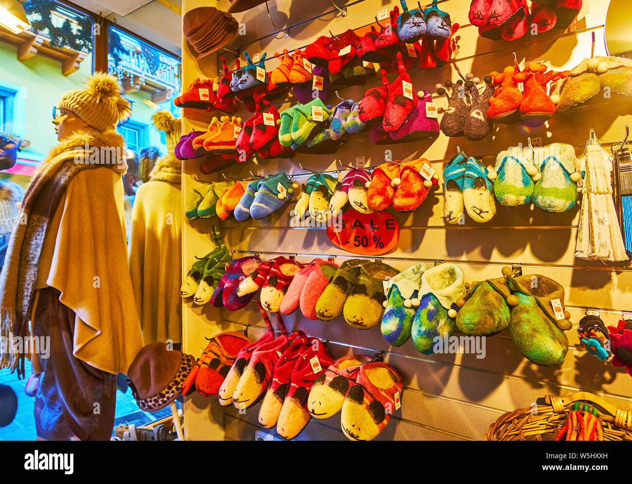 ZELL AM SEE, AUSTRIA - FEBRUARY 28, 2019: The garment store offers wide range of colorful handmade felted wool slippers in shape of mice and fairy tal Stock Photo