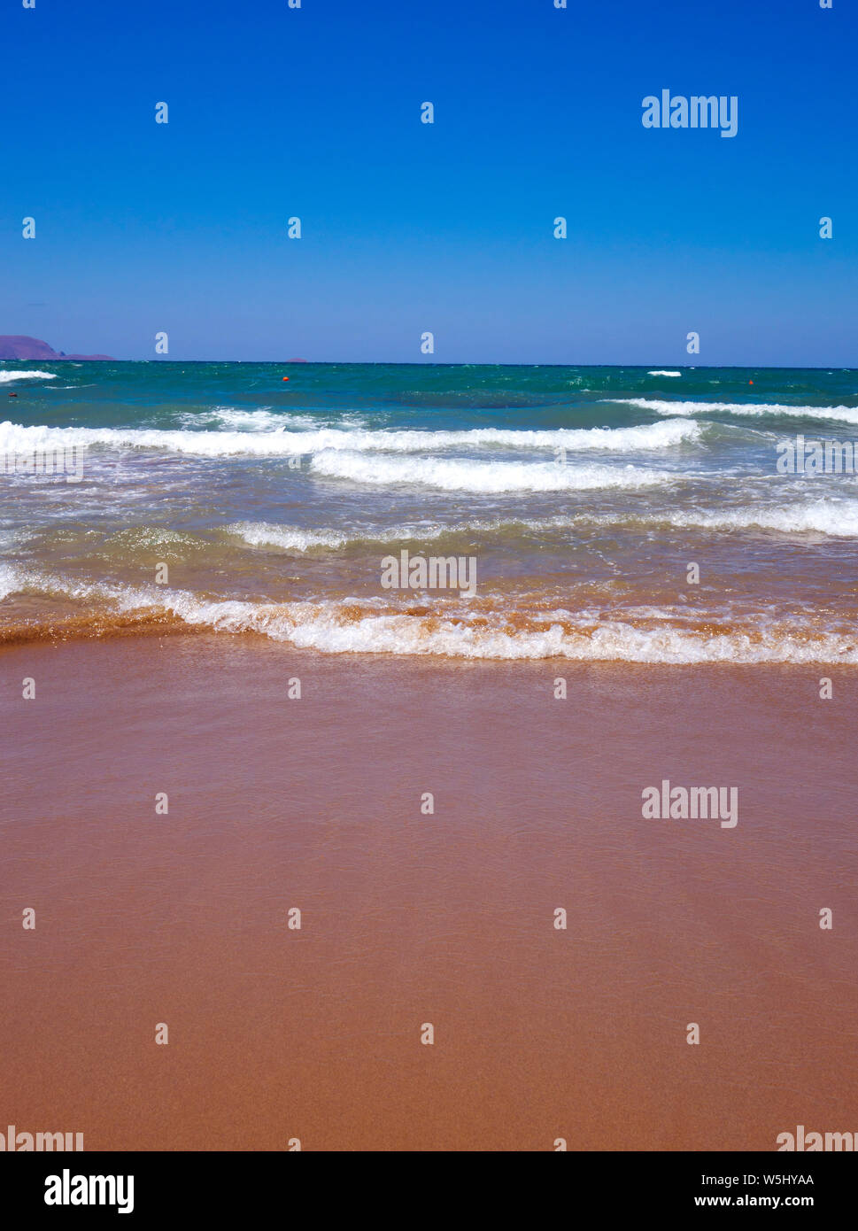 waves lapping onto a beach Stock Photo