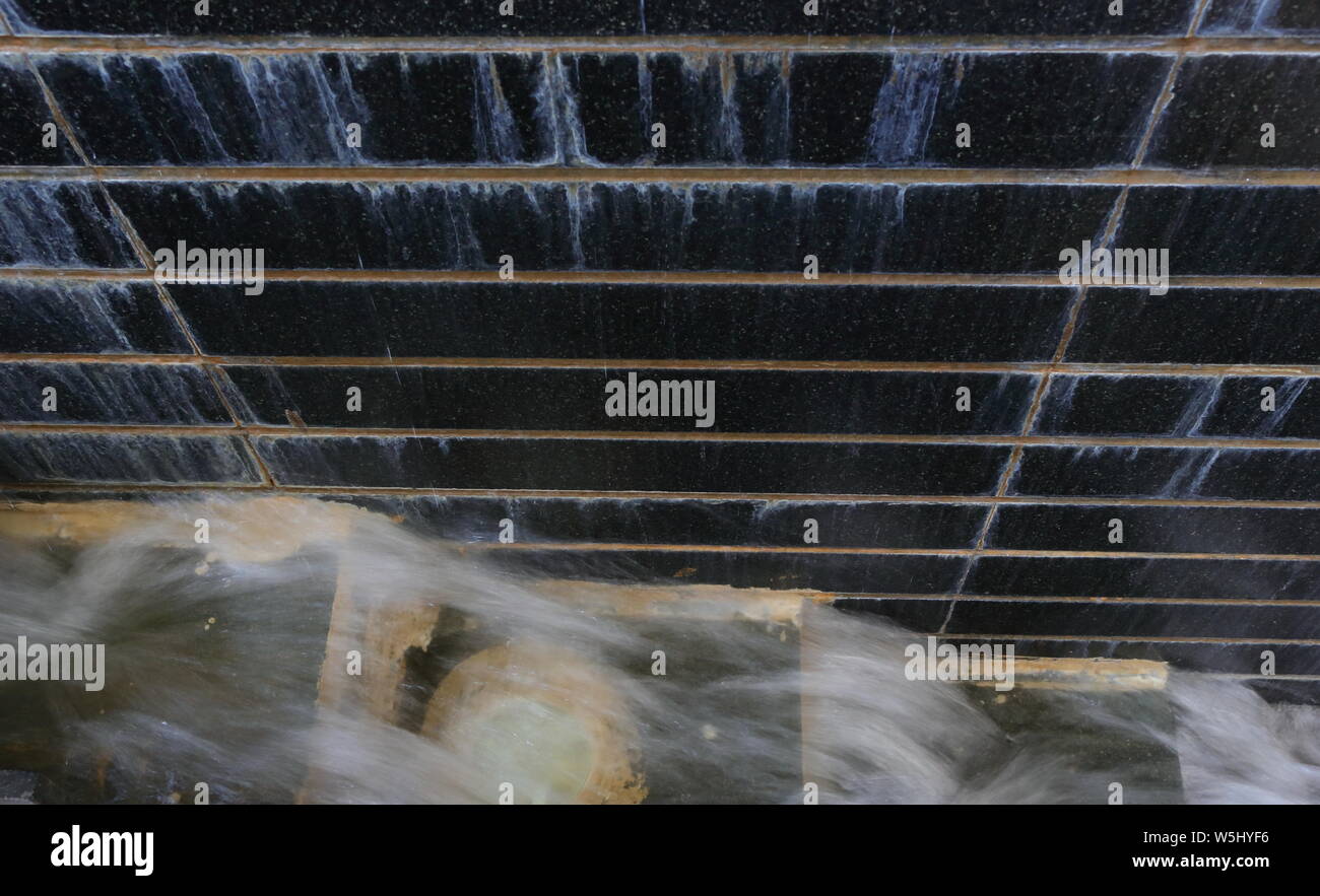 Blurred Motion Of Water Flows From High Step To Low Step And Stone Wall With Water Falls High To Low Concept Stock Photo Alamy