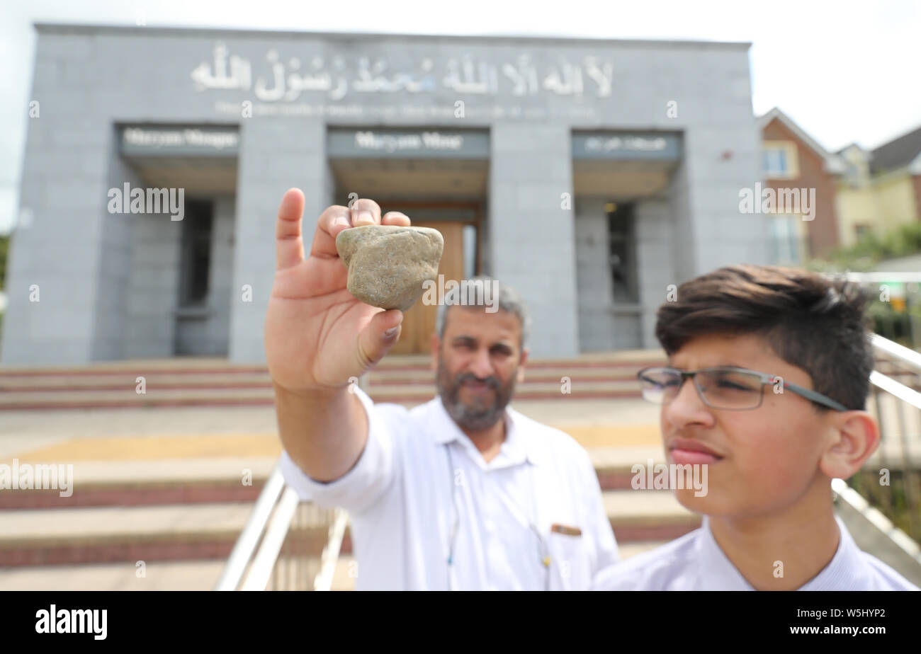 Shareef Mubashir, caretaker of Ahmadiyya Mosque in Galway and his son Mahmood with one of the rocks used in a break in at the premises on Sunday. Stock Photo
