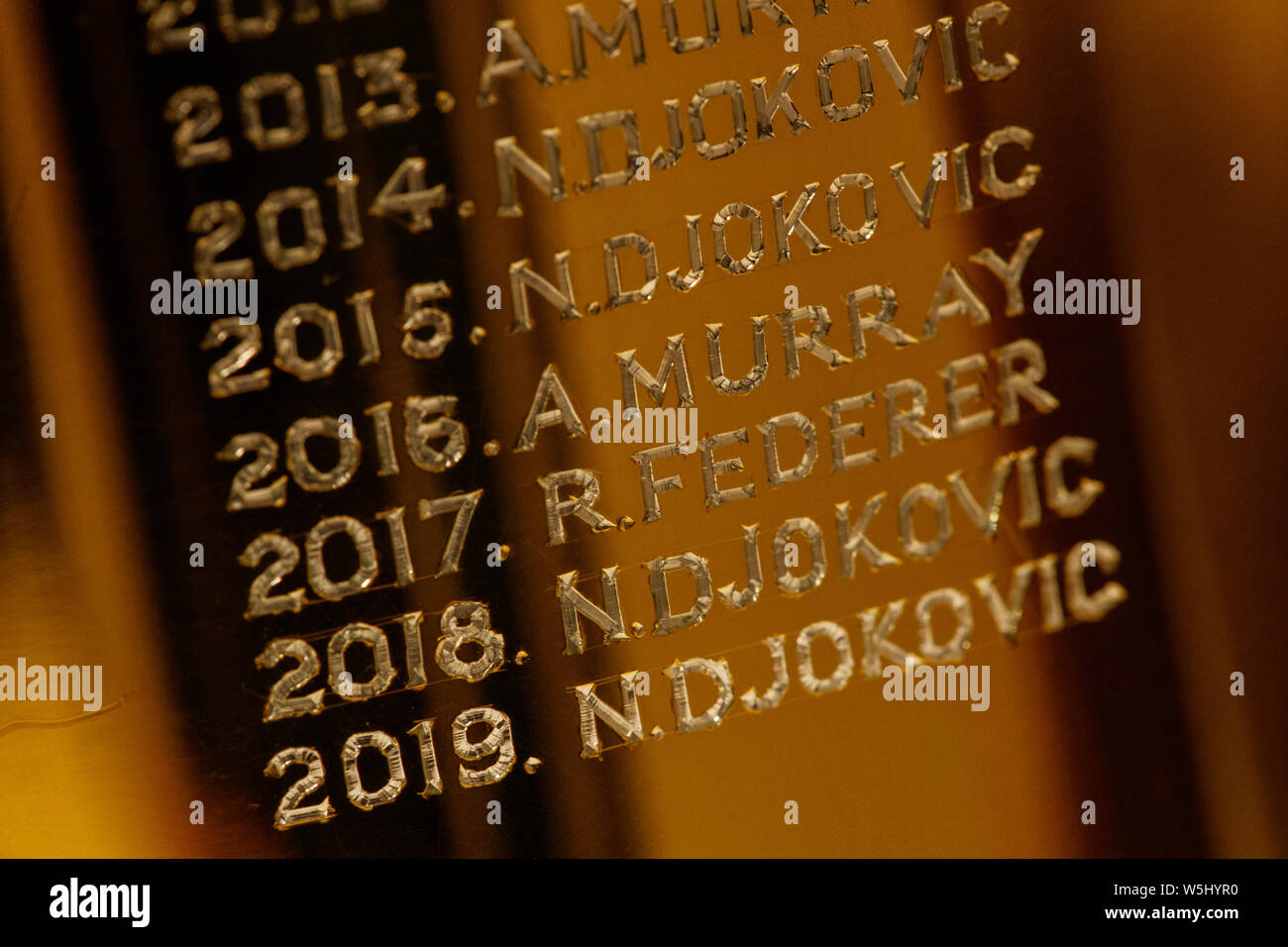 Detail engraving the 2019 winner, Novak Djokovic, on The Gentlemen's Singles Trophy at The Championships at Wimbledon. Stock Photo