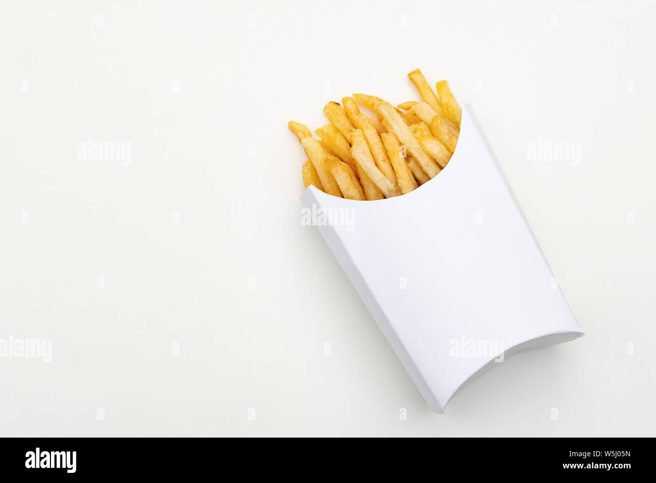 A portion french fries in a white cardboard box. White paper background and  packaging provide copy space for your own creative ideas Stock Photo - Alamy